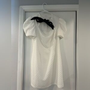 White mini dress with black bow